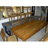 A 20th Century rectangular teak dining table on square section tapering legs,