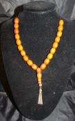 An amber beaded necklace CONDITION REPORTS Housed on a modern string.