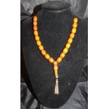 An amber beaded necklace CONDITION REPORTS Housed on a modern string.