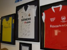 A collection of three framed and glazed football shirts including Arsenal Soccer School Costa Del