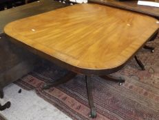 A mahogany and cross banded snap-top tea table on turned support to four cabriole legs terminating