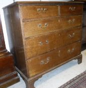 An oak chest of two short over three long drawers