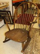A dark elm and beech Ercol rocking chair, a pair of Lloyd Loom tub chairs and a matching stool,