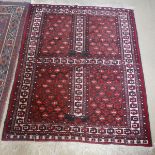A Hatch Li rug, set with two panels, each with pillar, on a black ground with red decoration,