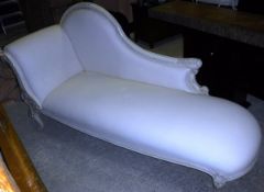 A cream painted framed chaise longue with cream upholstered back end and seat