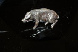 A patinated bronze pig figure