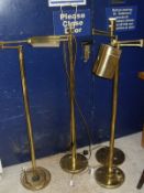 Four modern brass floor lamps