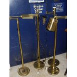 Four modern brass floor lamps