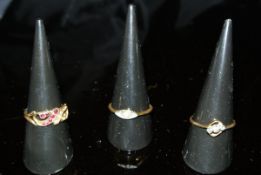 Two 18 carat gold dress rings, one set with three diamonds, the other with garnets and pearls,