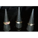 Two 18 carat gold dress rings, one set with three diamonds, the other with garnets and pearls,