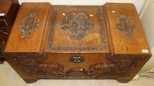 A modern Chinese hardwood chest with carved decoration,