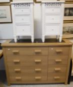 A modern veneered chest of four long and four short drawers with simulated oak finish,