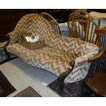 A Victorian chaise longue with shaped back and show front frame,