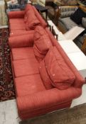 A modern two seat sofa in a red Nina Campbell fabric,