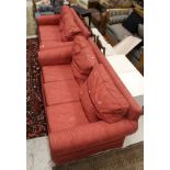 A modern two seat sofa in a red Nina Campbell fabric,