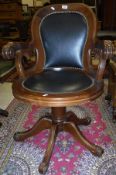 A reproduction mahogany framed swivel office chair with black leatherette upholstered back and seat