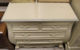 A modern cream painted chest of two short over three long drawers, with shaped apron,