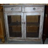 A Continental painted pine food cupboard of two drawers over two wired cupboard doors