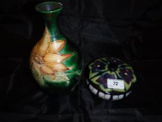A modern Moorcroft pot and cover decorated in the Mackintosh style with floral medallions (date