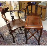 A pair of Chinese rosewood corner chairs with carved decoration of birds amongst prunus blossom in