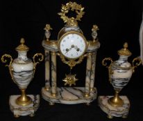 A 19th Century French alabaster cased clock garniture,