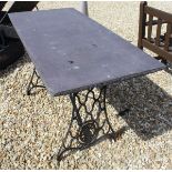 An early 20th Century cast iron painted Singer sewing machine table base with slate top