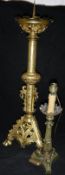 A Gothic style gilt brass pricket candlestick in the Victorian manner and an Empire style