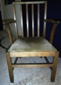 A Castle Bros oak stick back carver chair after a design by Gordon Russell,