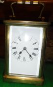 A lacquered brass cased carriage clock,