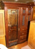 A Victorian rosewood wardrobe compactum with single mirrored door beside a two door cupboard with