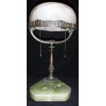 An early 20th Century table lamp with domed white alabaster shade raised on a bronzed Y shaped