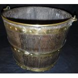 A coopered oak and brass bound bucket with swing handle, a copper two-handled jug,