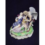 A Derby figural group of a winged figure blood letting recumbent maiden whilst Cupid looks on