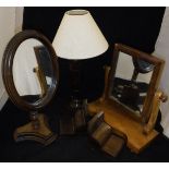 A Victorian dressing mirror, pair of book ends, two mahogany table lamps, oval shaving mirror,