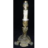 A 19th Century gilt brass candlestick in the Rococo taste with C scrolling foliate,