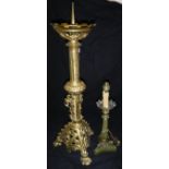 A Gothic style gilt brass pricket candlestick in the Victorian manner and an Empire style