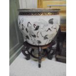A 20th Century Chinese porcelain fish bowl decorated with storks,