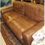 A two seat brown leather sofa and a matching foot stool CONDITION REPORTS Various