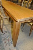 A modern pine rectangular farmhouse style table on square tapering legs