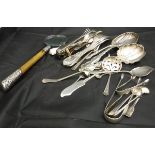 A collection of silver and plated ware to include sugar tongs, serving spoons, sifter spoons,