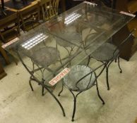 A modern black painted wrought iron framed glass topped table on an X framed base,