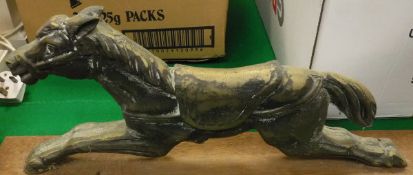 A cast metal doorstop in the form a horse,