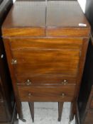 A Regency mahogany night table with doulbe rising top above a cupboard drawer and commode drawer