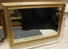 A rectangular modern 20th Century gilt framed wall mirror