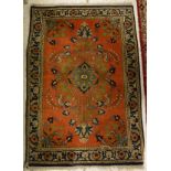 A Persian rug, the central panel set with floral spray on a red ground within a stepped blue,