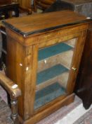 An early 19th Century walnut and inlaid single glazed door cabinet enclosing three shelves to