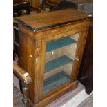 An early 19th Century walnut and inlaid single glazed door cabinet enclosing three shelves to