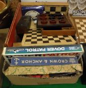 A box of assorted games to include a cased set of double nine dominoes, various chess sets,