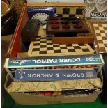 A box of assorted games to include a cased set of double nine dominoes, various chess sets,