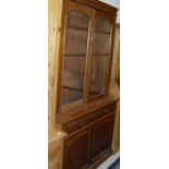 A Victorian mahogany bookcase cabinet with two glazed doors enclosing adjustable shelving over two